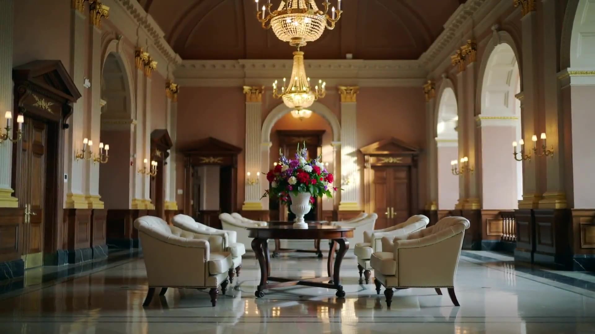 A grand independent hotel lobby with a chandelier and lounge seating, ready to greet guests.